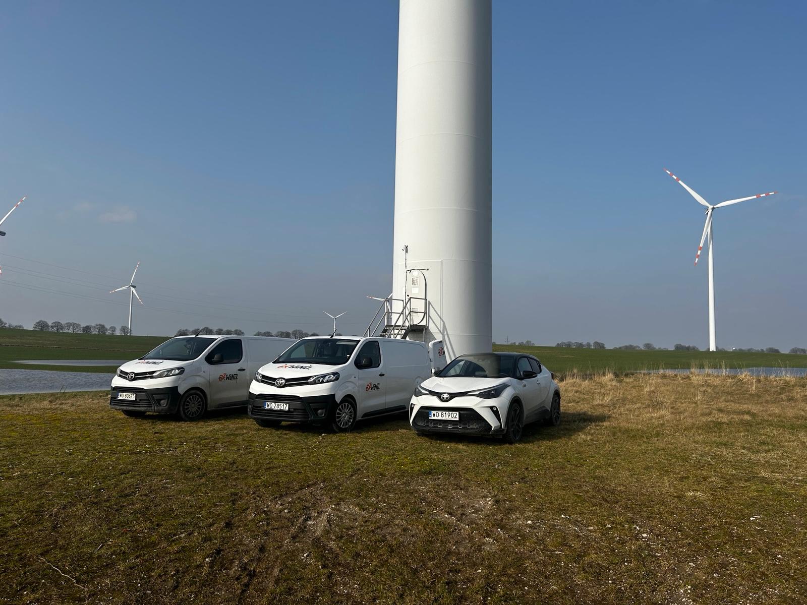 ExWind service vehicles parked at a wind turbine