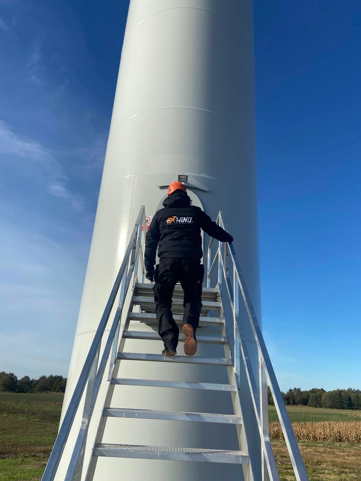 ExWind technician climbing turbine access stairs